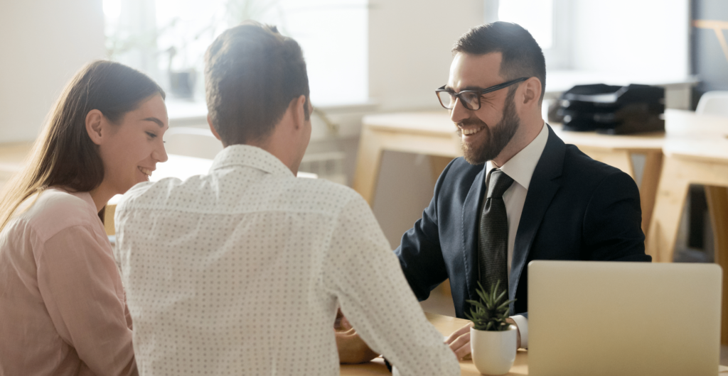 Woman and man having a meeting with a smiling office worker